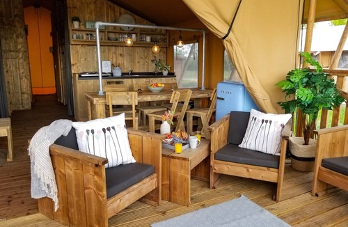 Bant RV Rental | Campsite - Combined Tents With Kitchen and Bathroom Located Near a Pond